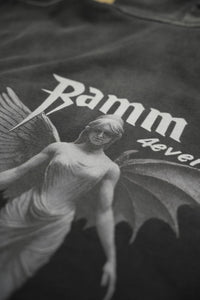 Vintage washed black streetwear hoodie with angel figure graphic print detail and minimalist logo design shown in a close-up view.