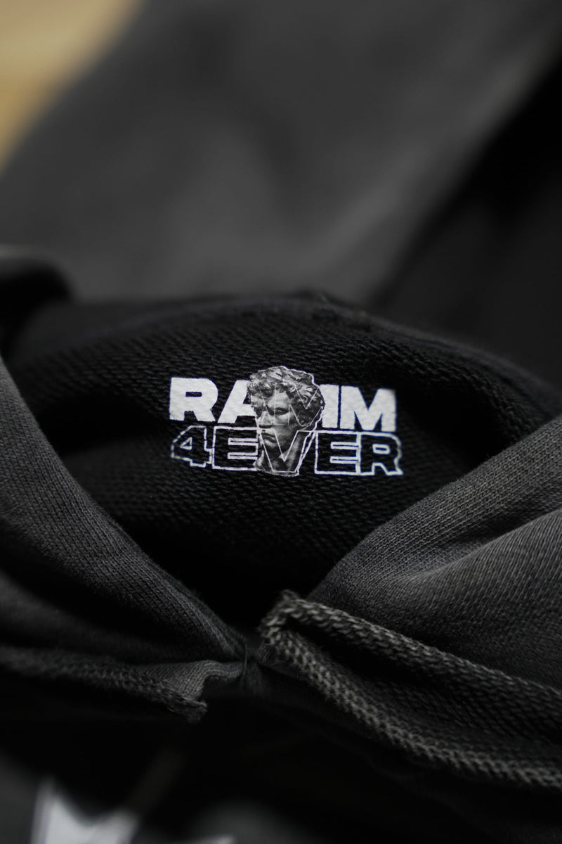 Vintage washed black streetwear hoodie with inner neck branding and RAMM4EVER logo detail shown in a close-up view.